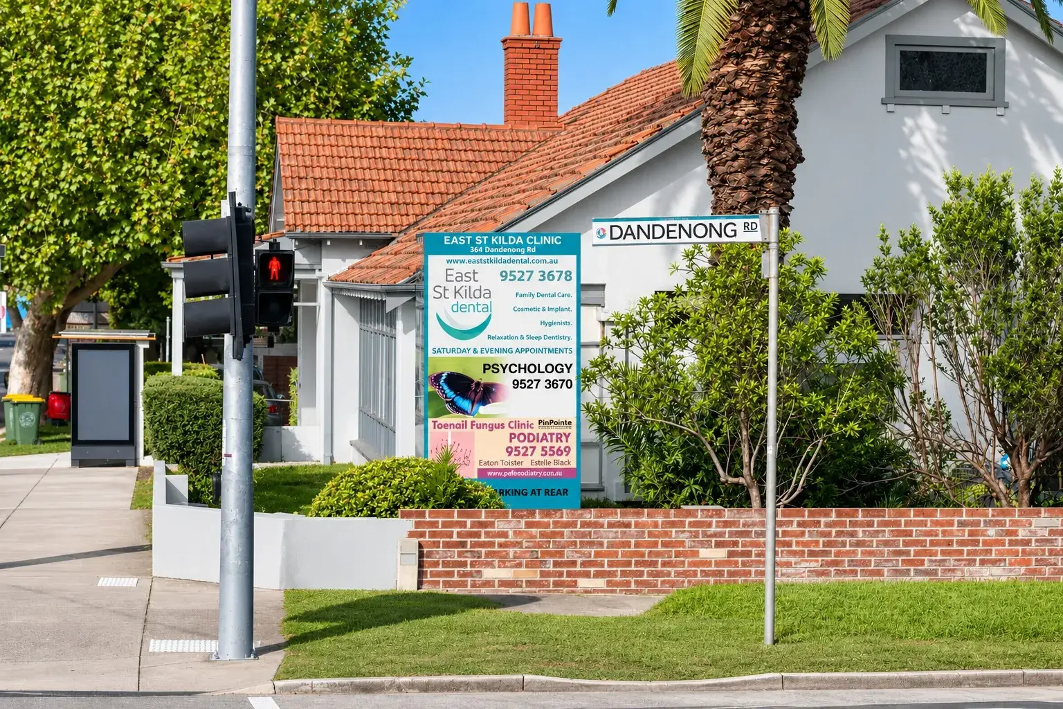 The East St Kilda Dental clinic on the corner of Dandenong Rd, its sign out front beside the street sign