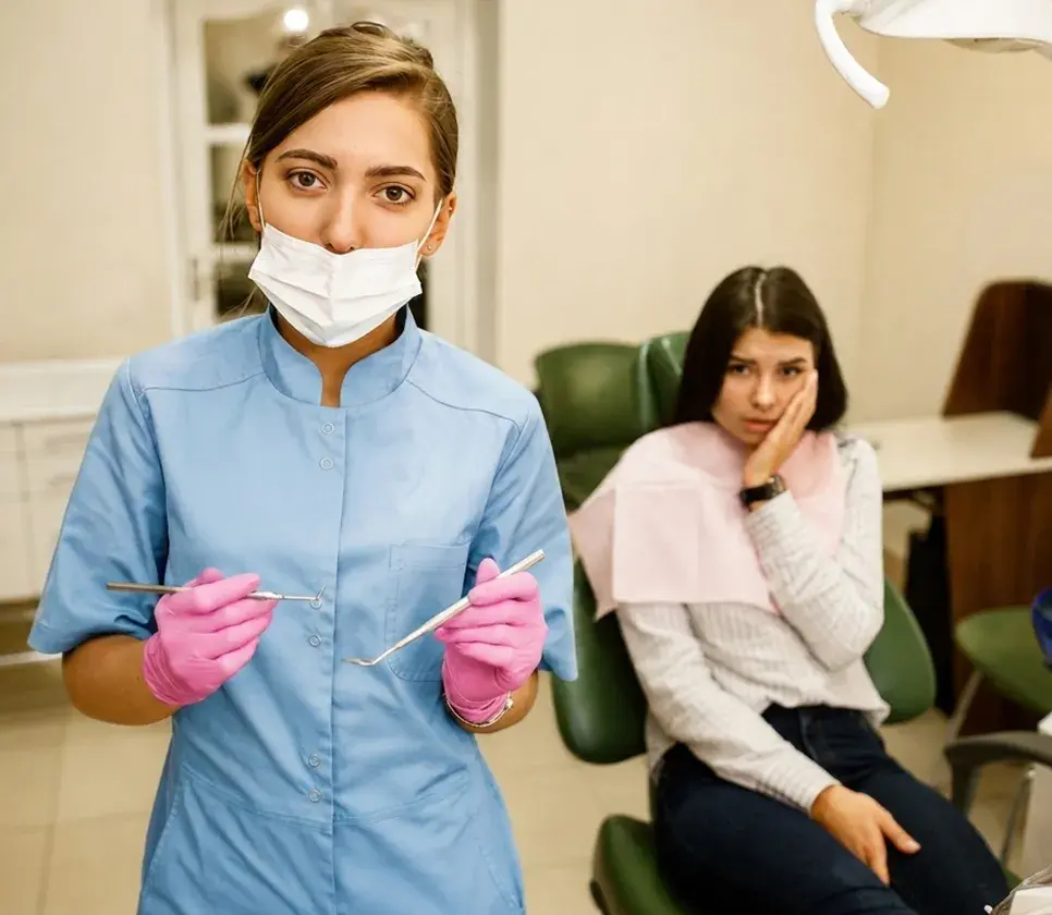 Dentist explaining an X-ray to a patient in the chair
