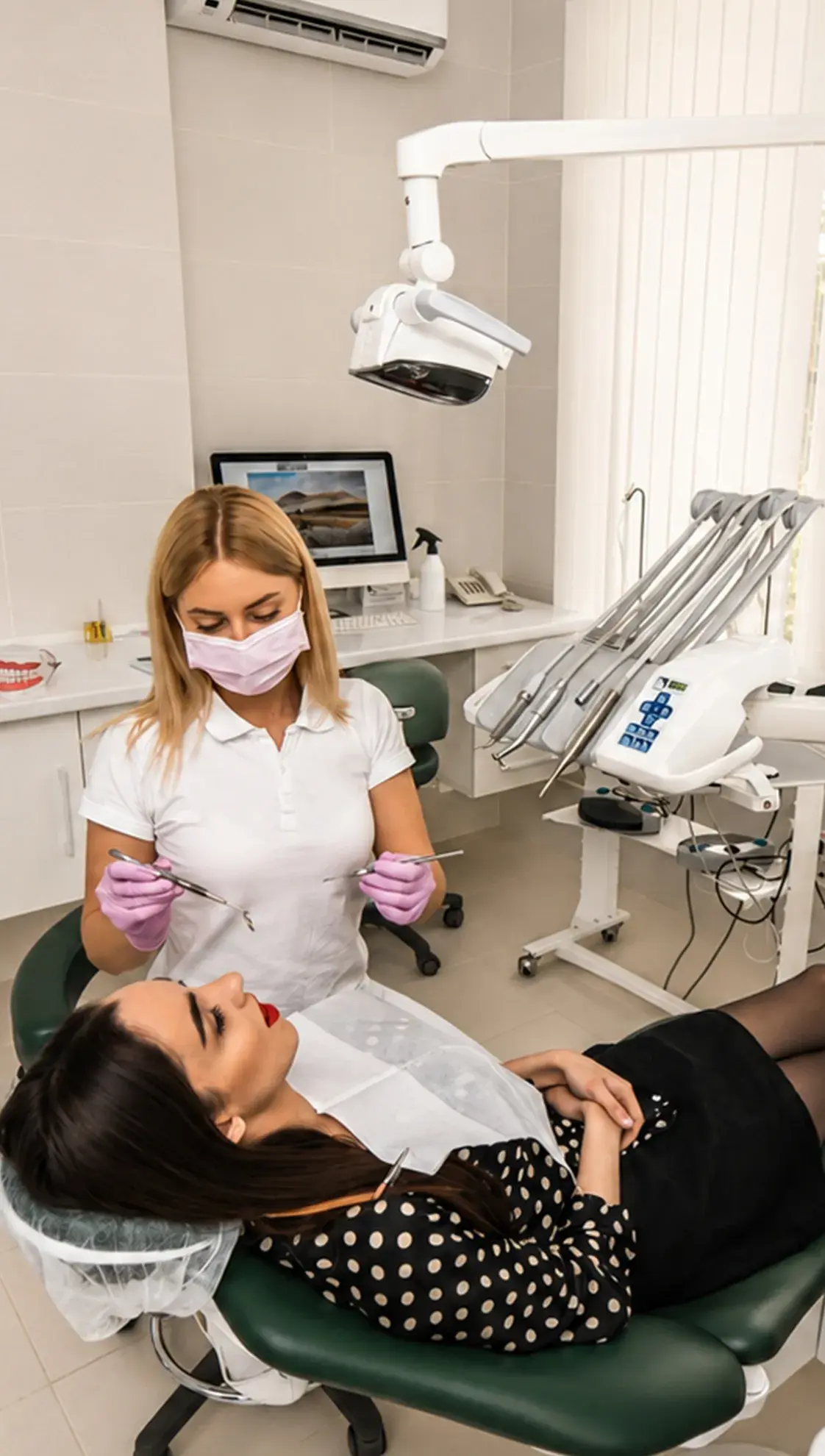 A dentist and patient reviewing a dental X-ray together on screen during a consultation