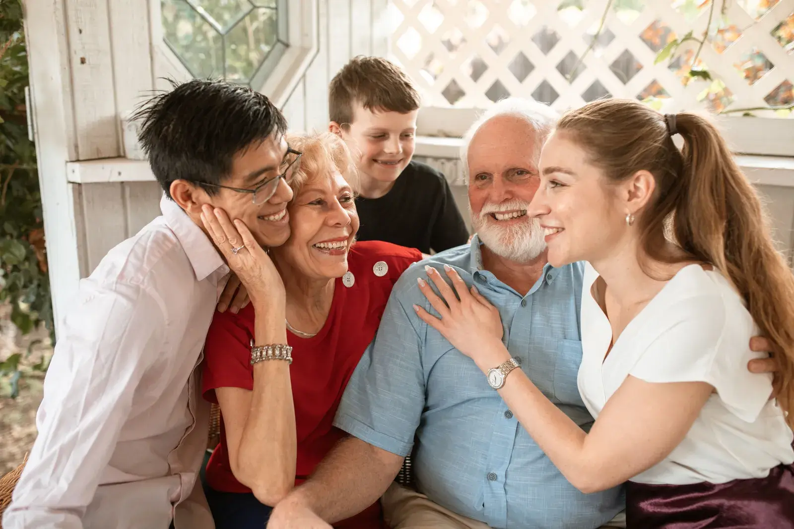 Three generations of a family embracing and laughing together