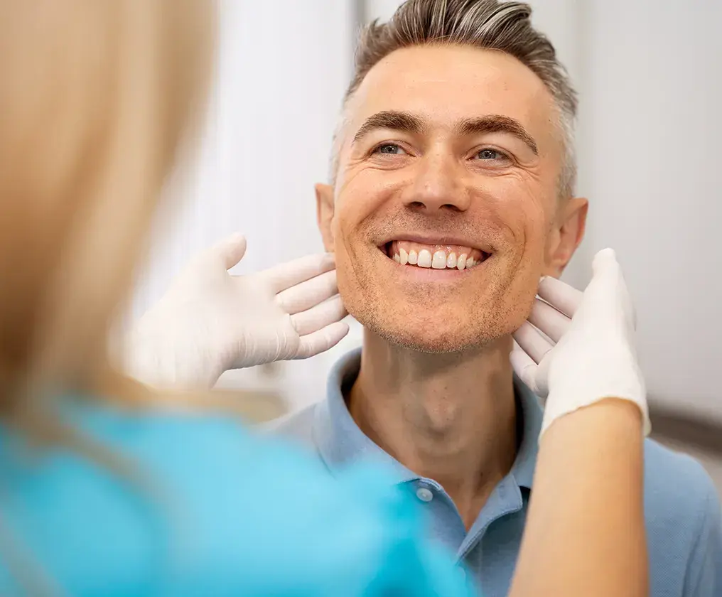 A dentist and patient talking through a care plan together at the clinic